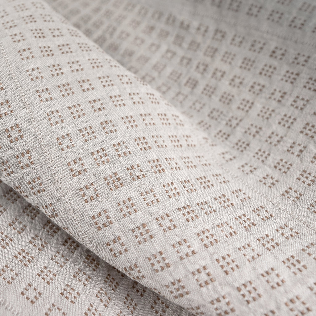 _120 | poppy oatmeal - ann rees: Beige colored linen fabric with delicate camel colored pattern.